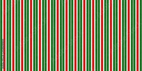 Red and green vintage rough kraft textured seamless vertical pin stripes Christmas decoration pattern. Classic xmas card background or gift wrap, wrapping paper or, winter holiday backdrop.