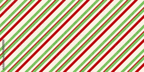 Red and green vintage rough kraft textured seamless diagonal candy cane stripes Christmas decoration pattern. Classic xmas card background or gift wrap, wrapping paper or, winter holiday backdrop.