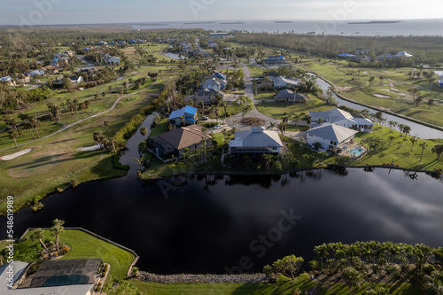 Hurricane Ian destroyed homes in Florida residential area on golf course. Natural disaster and its consequences photo