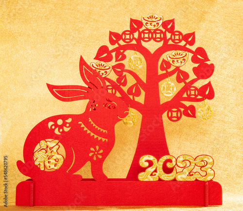 Chinese New Year of Rabbit mascot with cash cow on gold background the Chinese word means fortune no logo no trademark