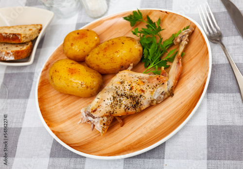 Appetizing dish of stewed rabbit with spices and boiled potatoes