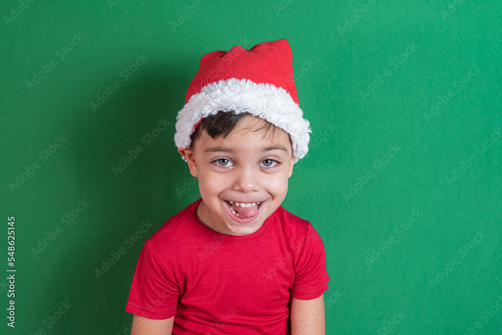 Happy and smiling boy with christmas hat Happy and smiling boy with christmas hat