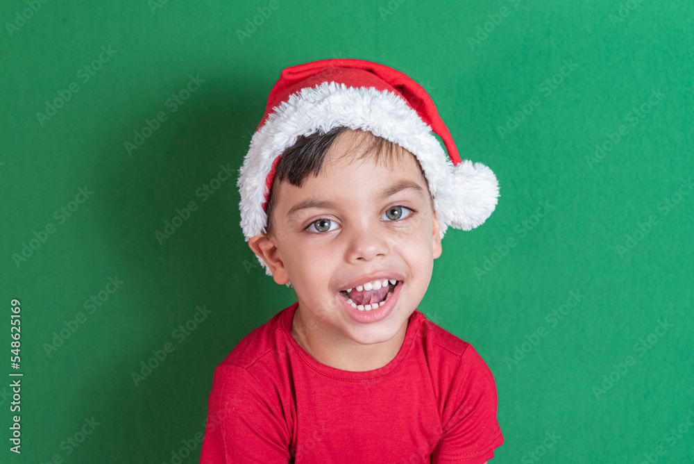 Happy and smiling boy with christmas hat Happy and smiling boy with christmas hat