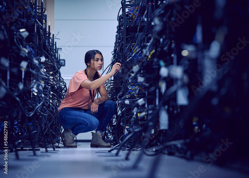 Female technician working in server room