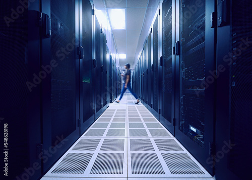 Female technician walking in server room