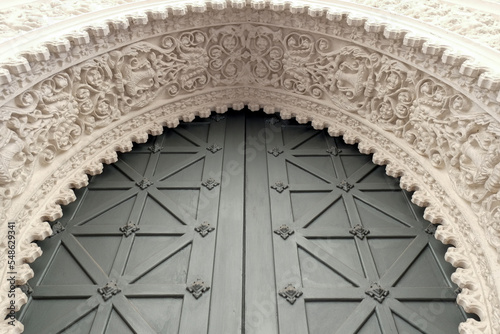 Spain, Seville, Decorative arch above metal door