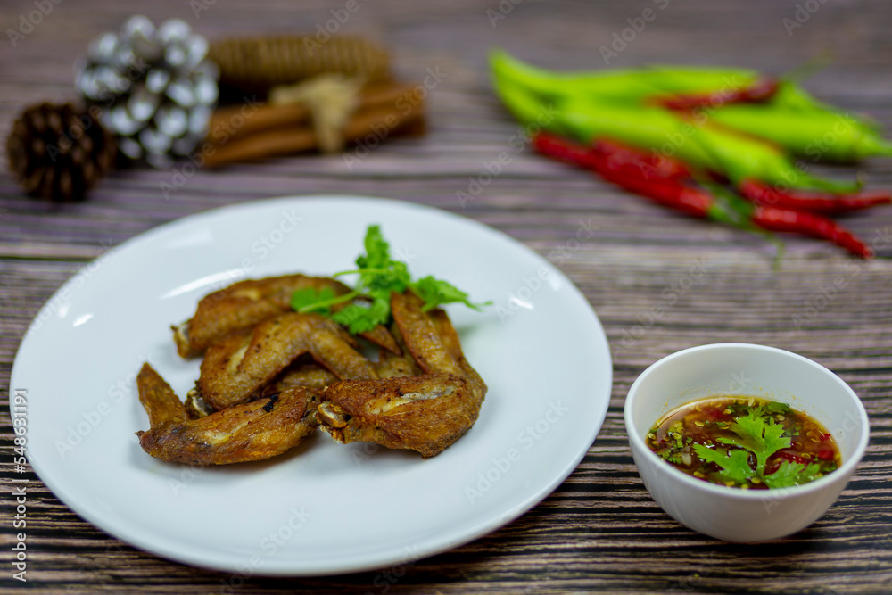 Fried Chicken Wings garlic pepper serve with spicy dipping sauce Thai style and eat with alcoholic beverages it's compatible with each other very well. Fried Chicken Wings garlic pepper serve with spicy dipping sauce Thai style and eat with alcoholic beverages it's compatible with each other very well.