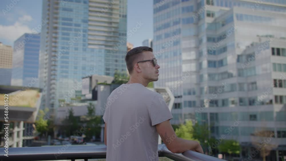 Young attractive male in the city, looking at city skyline, vancouver Young attractive male in the city, looking at city skyline, vancouver