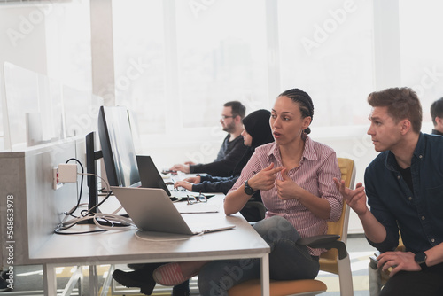 Fotografija Collaborative process of multicultural skilled young business team during brainstorming meeting in office
