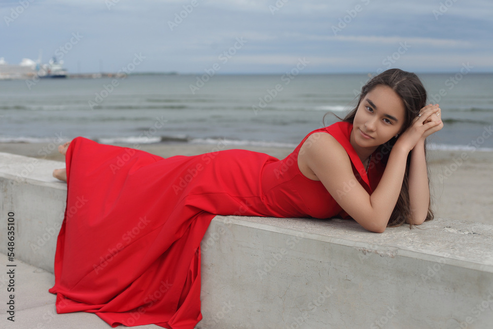 young asian teen in red long dress