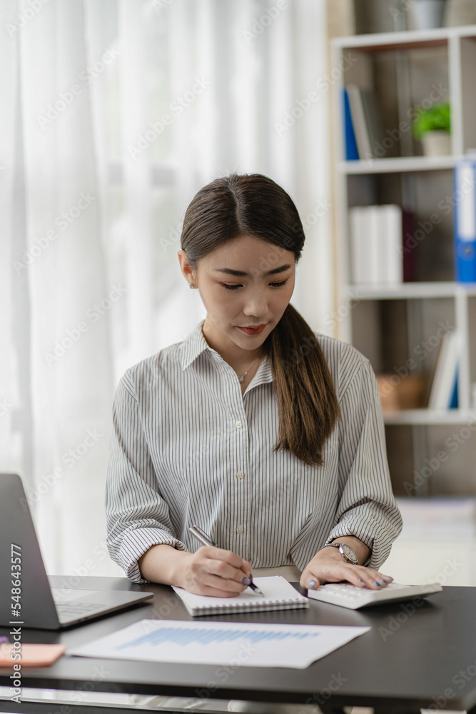 Financial and Investment Accountant Tax and Budget Calculations Asian female entrepreneur using laptop to document company business results vertical image Financial and Investment Accountant Tax and Budget Calculations Asian female entrepreneur using laptop to document company business results vertical image