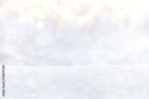 Blurred Christmas lights on a snowy background. Winter background, white snow, glitter defocused festive lights, bokeh, Snowflakes © maxa0109