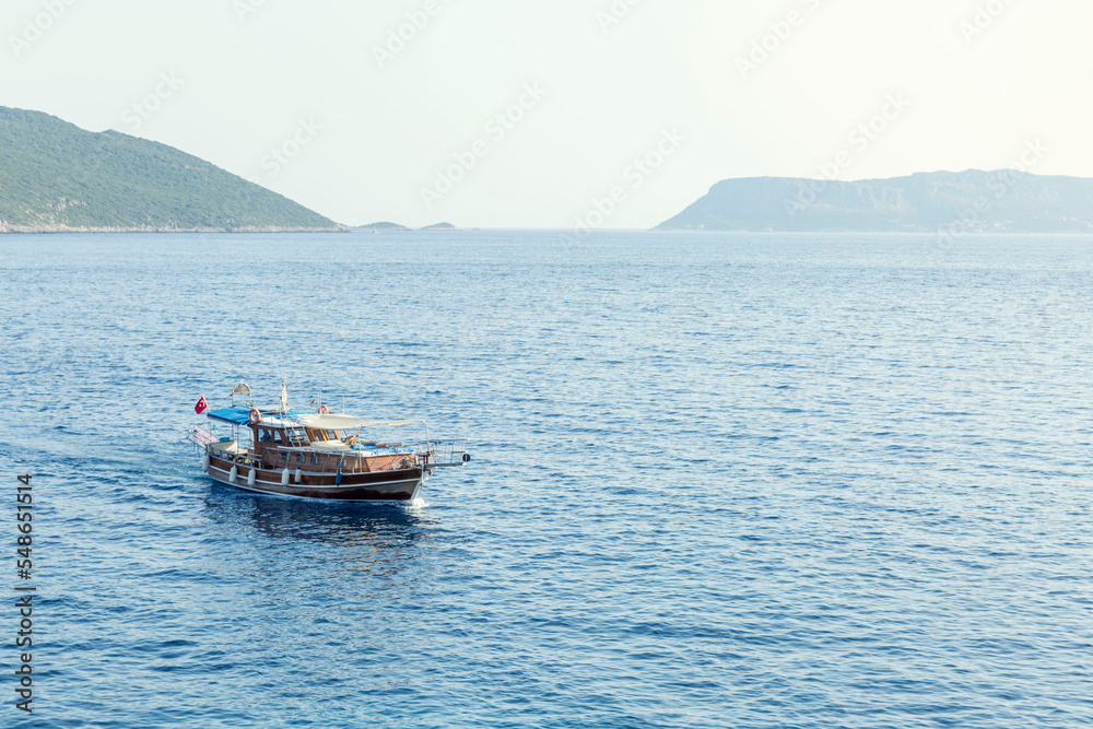 Stylish pleasure boat in the sea on a sunny day. Pleasure and relaxation.