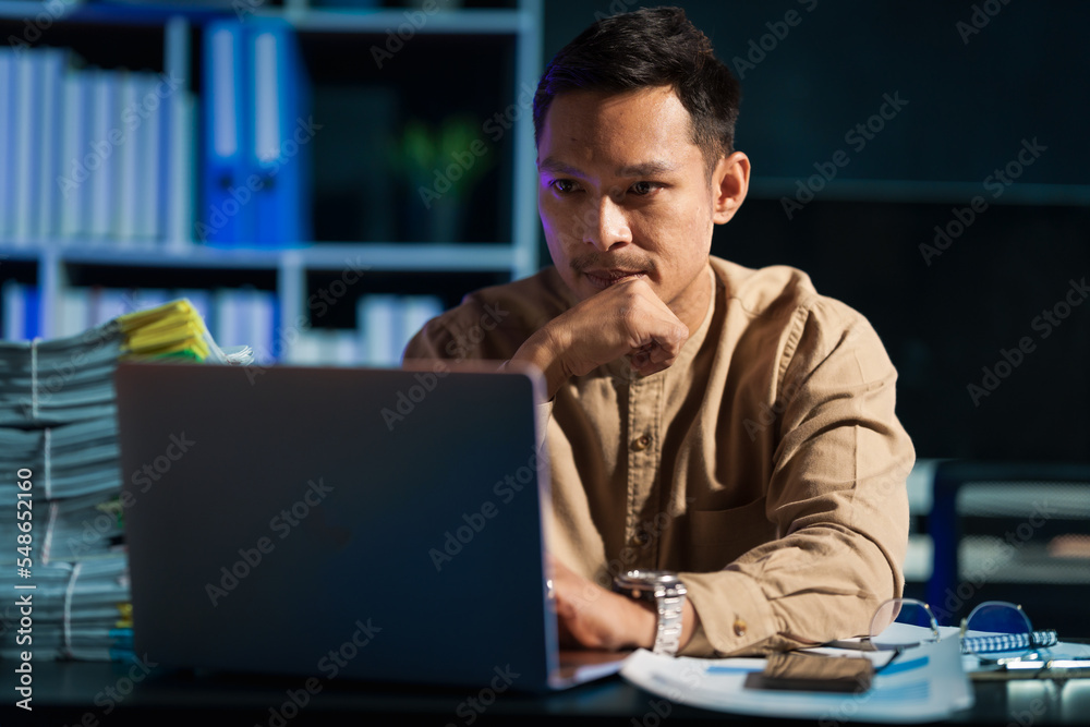 Overtime work concept, Handsome asian business man working late at night in office workplace. Overtime work concept, Handsome asian business man working late at night in office workplace.