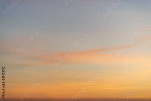 The dramatic colors of the sunset in the sky gradient from blue to orange. © EKKAPON