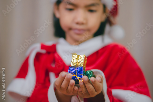 Children's hands holding small presents for Christmas and New Year. © PayonGrahy