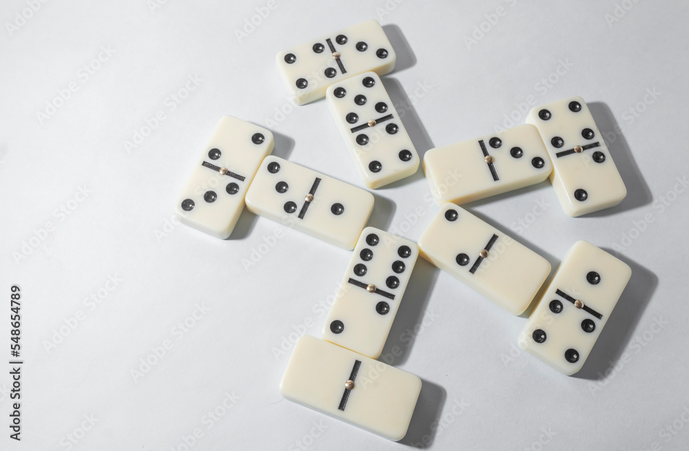 Domino pieces with white background, copy space and various agulos, concept of table games Domino pieces with white background, copy space and various agulos, concept of table games