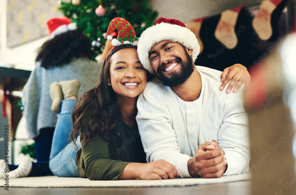 Love, happy and portrait of a couple at christmas party relaxing on the floor together in living room. Happiness, smile and young man and woman at festive holiday event for xmas celebration at house. Love, happy and portrait of a couple at christmas party relaxing on the floor together in living room. Happiness, smile and young man and woman at festive holiday event for xmas celebration at house.