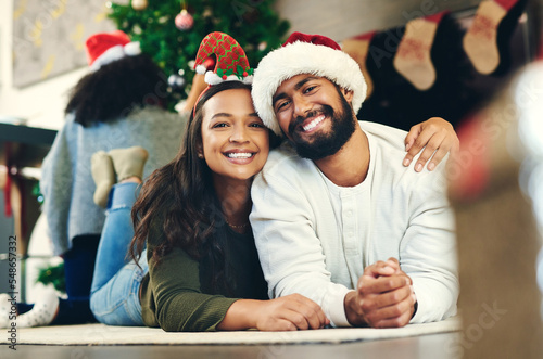 Love  happy and portrait of a couple at christmas party relaxing on the floor together in living room. Happiness  smile and young man and woman at festive holiday event for xmas celebration at house.