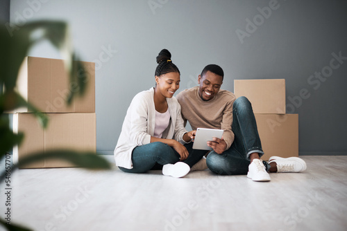 Real estate, property and black couple with boxes and tablet for furniture shopping or search renovating ideas. Happy owners, relocation and tenants on digital touchscreen on moving day in new home.