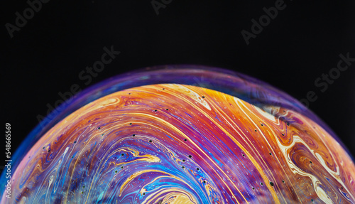 Virtual reality space with abstract multicolor psychedelic planet. Closeup Soap bubble like an alien planet on black background