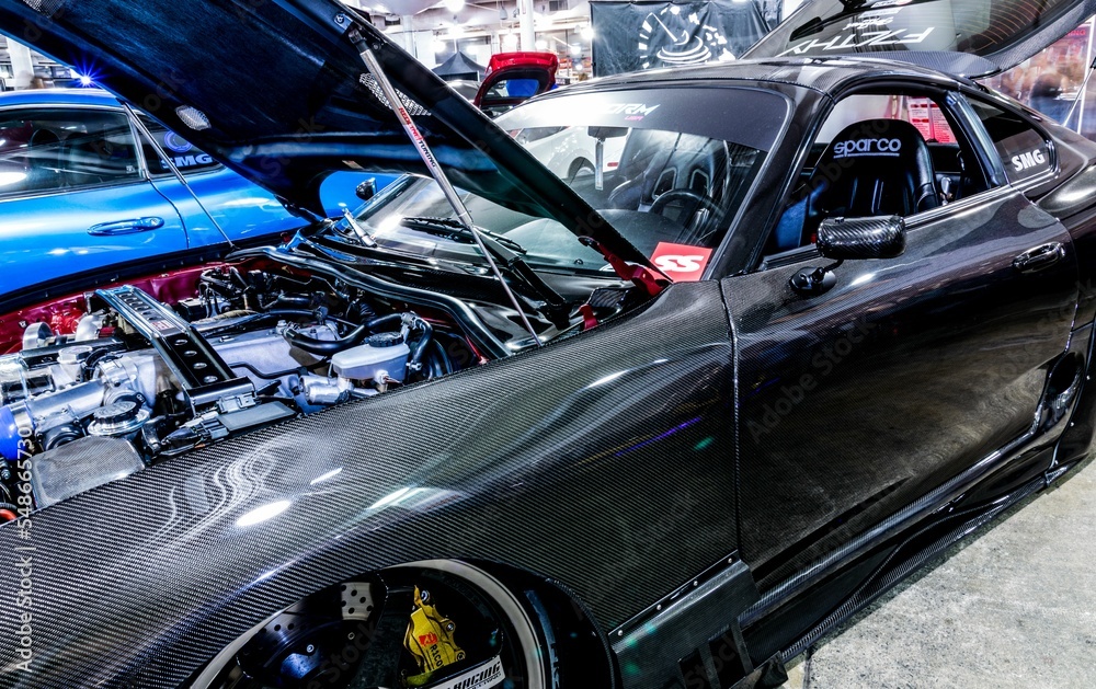Side view of a gray Toyota Supra with an open hood at Hot Import Car