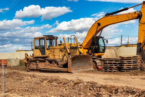 Powerful construction equipment for the construction of a new facility. Construction equipment for earthworks. Modern building site. Excavators, bulldozers, loaders, graders.