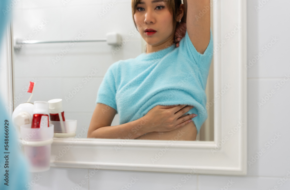 Breast Cancer, World cancer day. Young Asian woman examining, palpation for a lump or cancer in the breast.