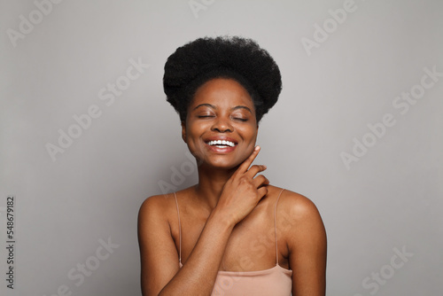 Laughing woman brunette female model portrait. Beauty, facial treatment, skin care and wellness concept