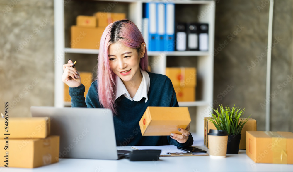 Young asian Woman Thinking and Working on sell online in cozy house, Modern Lifestyle of New Generation People. Young asian Woman Thinking and Working on sell online in cozy house, Modern Lifestyle of New Generation People.