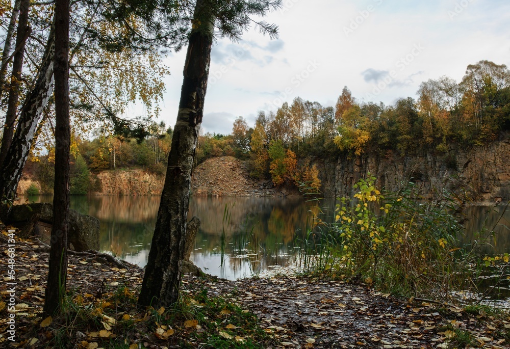 Fototapeta premium The shore by the flooded old quarry. Autumn. Opatovice. Czechia.