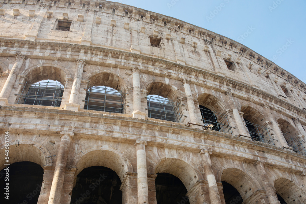 Coliseum (Colosseum), Rome, Italy. Ancient Roman Coliseum is famous landmark, top tourist attraction of Rome. Scenic view of Coliseum with blue sky.