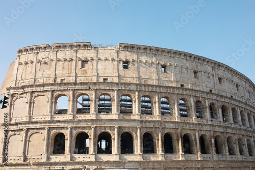 Coliseum (Colosseum), Rome, Italy. Ancient Roman Coliseum is famous landmark, top tourist attraction of Rome. Scenic view of Coliseum with blue sky.