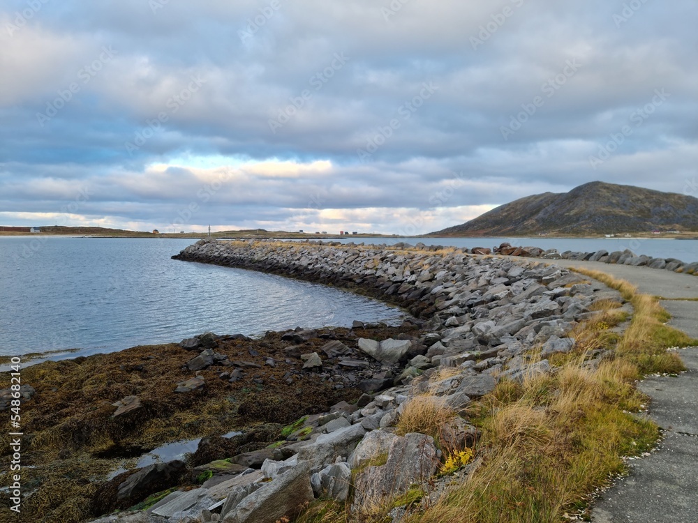 rock pier with concrete road going into the sea on a small island in the northern parts of Norway
