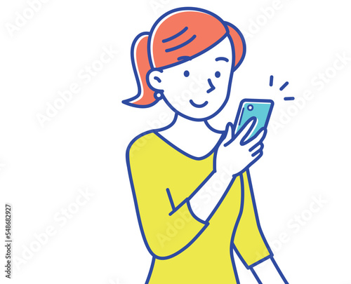 スマホの画面を見るポニーテールの若い女性