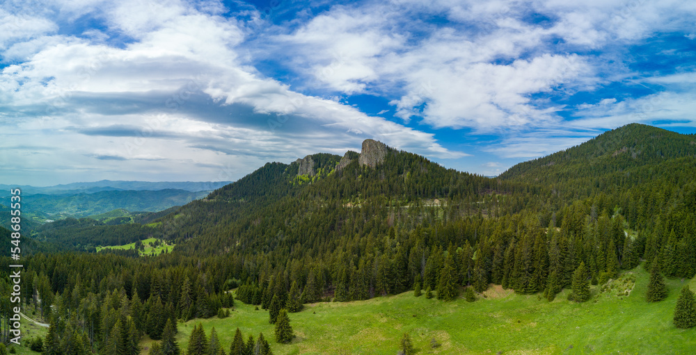 Peak with vegetation and forests against clouds in valley of Rhodope Mountains. Panorama, top view