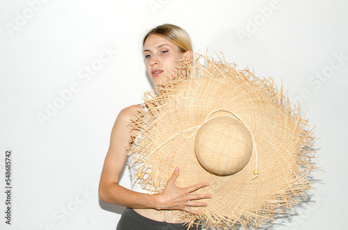 Portrait of young attarctive woman in straw hat	