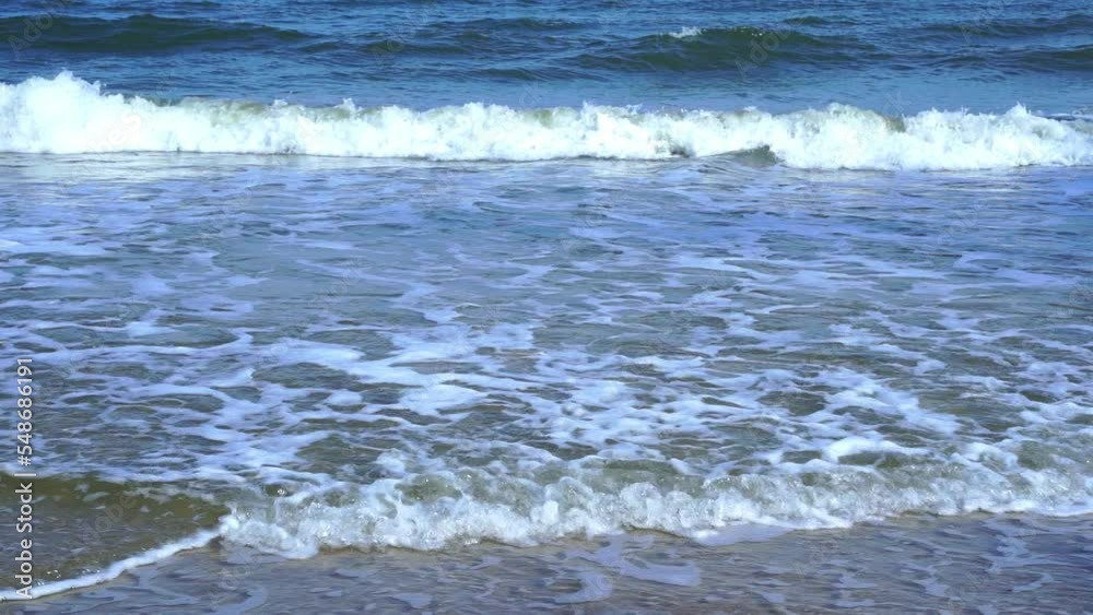 Light blue sea waves on a clean sandy beach.. Light blue sea waves on a clean sandy beach..