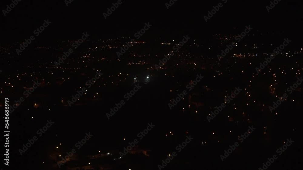 Lisbon at night seen from an airplane window while landing in slow motion Lisbon at night seen from an airplane window while landing in slow motion