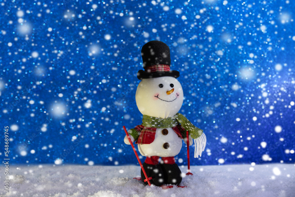 Happy snowman standing in winter sparkling christmas landscape. Merry christmas and happy new year greeting card with copy space .Snow background.