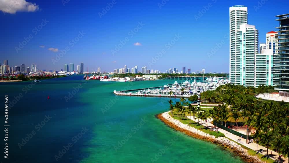 Aerial Lockdown: Shot Of Speedboats Moored At Harbor By Modern Buildings, Drone Flying Over Sea On Sunny Day - Miami, Florida Aerial Lockdown: Shot Of Speedboats Moored At Harbor By Modern Buildings, Drone Flying Over Sea On Sunny Day - Miami, Florida