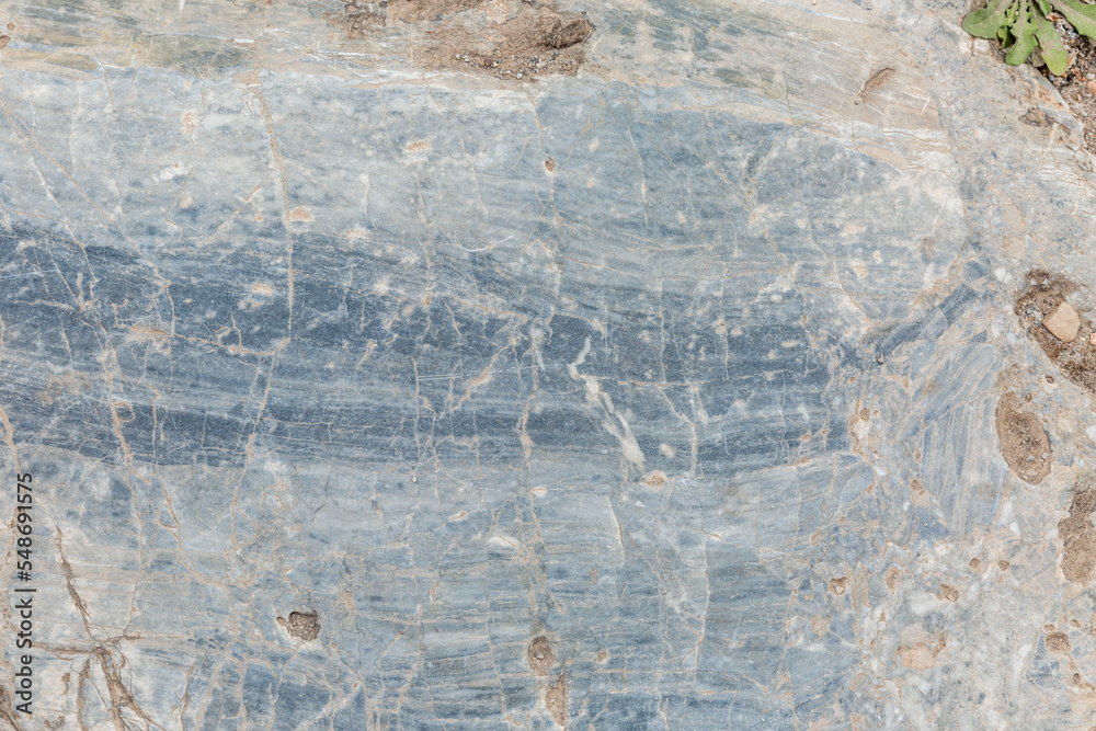 Fototapeta premium Surface of gray-beige sandy rock. Durable building material and archaeological site. Background. Space for text.