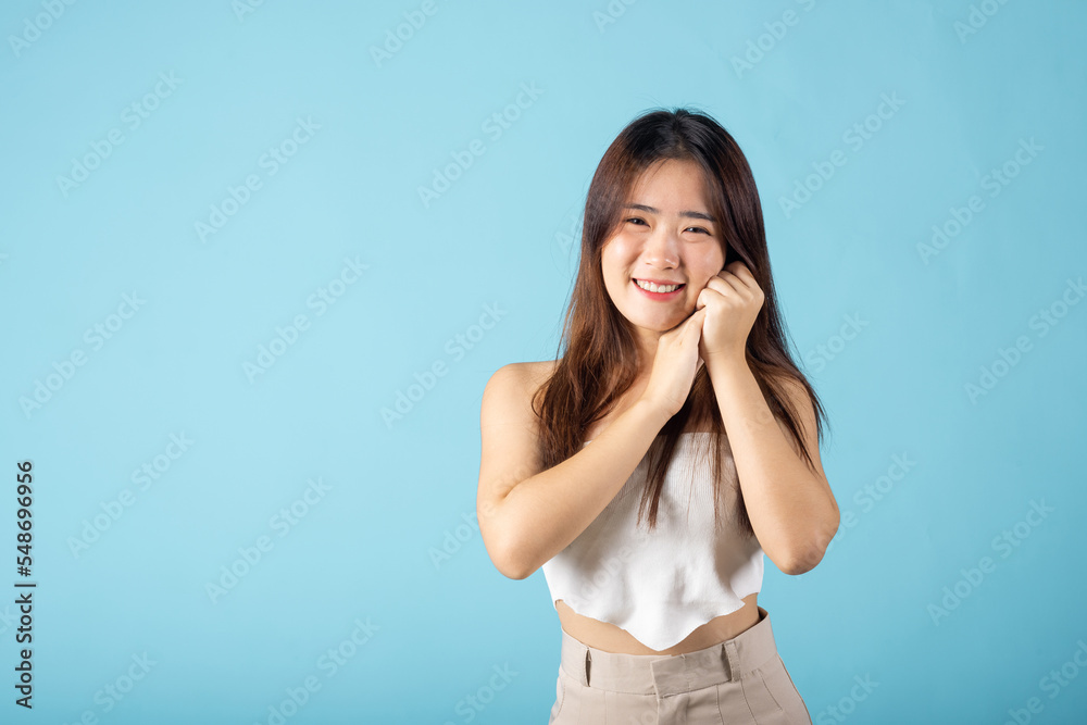 Close up woman smiling with natural makeup and healthy face, Asian young female with beauty face touching healthy facial skin studio shot isolated on blue background, Skin care and Beauty concept Close up woman smiling with natural makeup and healthy face, Asian young female with beauty face touching healthy facial skin studio shot isolated on blue background, Skin care and Beauty concept