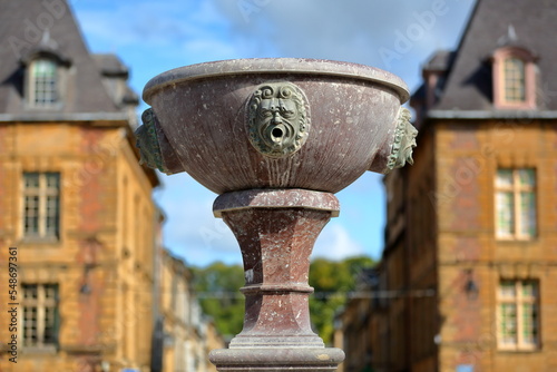 Close-up on details of the fountain located Place Ducale in Charleville Mezieres, Ardennes, Grand Est, France. Place Ducale in an architectural gem dated from 17 century photo