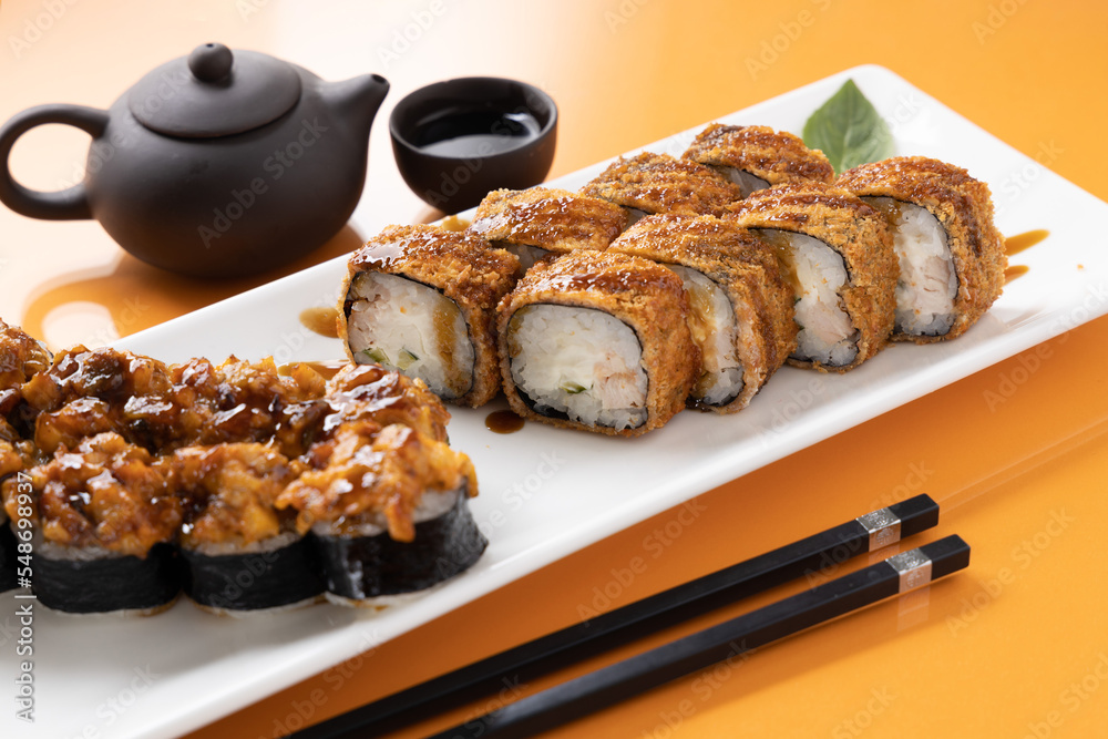 sushi and rolls on an orange background sushi and rolls on an orange background