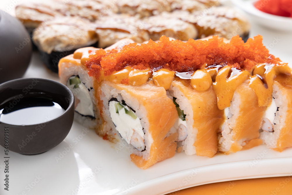 sushi and rolls on an orange background