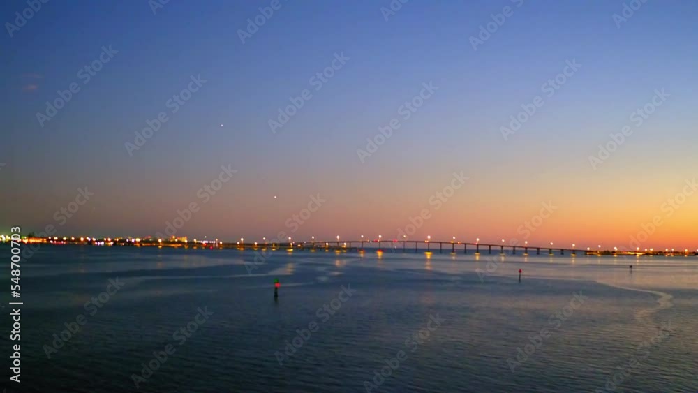 Aerial Forward Shot Of Illuminated Bridge Over Rippled Ocean Against Sky During Dusk - Miami, Florida Aerial Forward Shot Of Illuminated Bridge Over Rippled Ocean Against Sky During Dusk - Miami, Florida