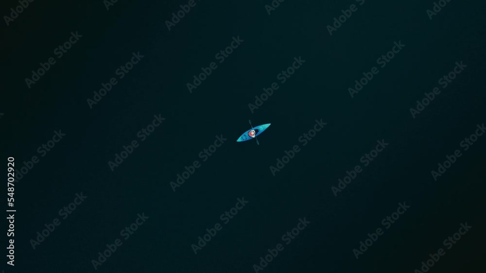 Lone Kayaker Adrift On Calm Lake Of Saint-Come In Quebec, Canada. aerial topdown Lone Kayaker Adrift On Calm Lake Of Saint-Come In Quebec, Canada. aerial topdown