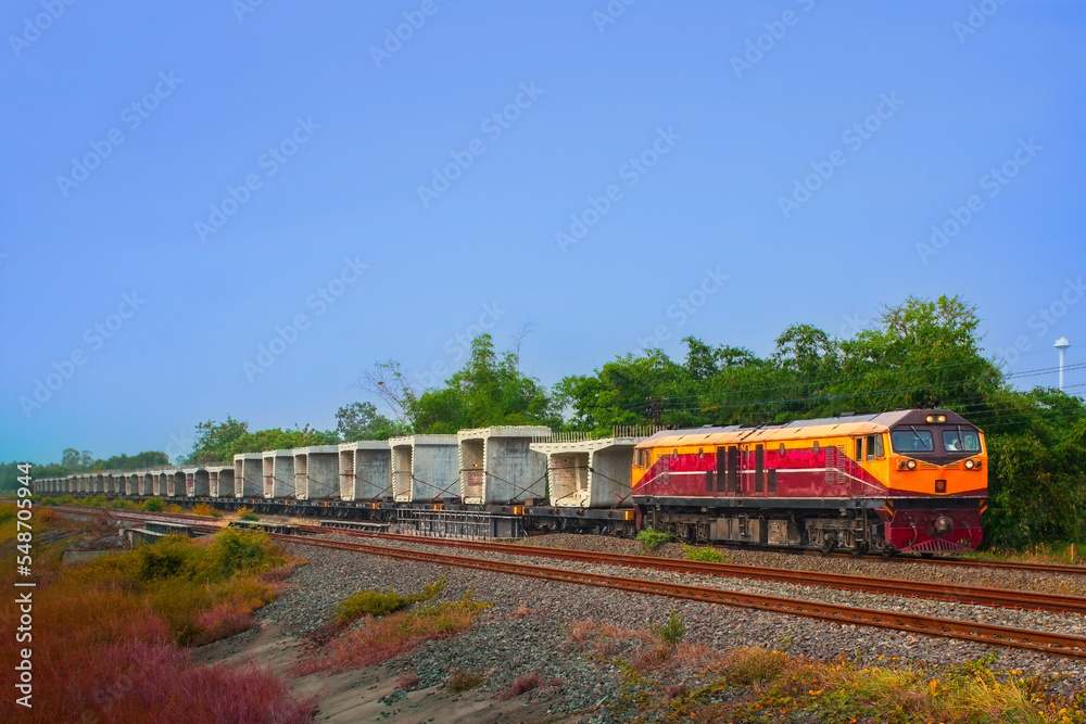 Freight train by diesel locomotive on the railway.
