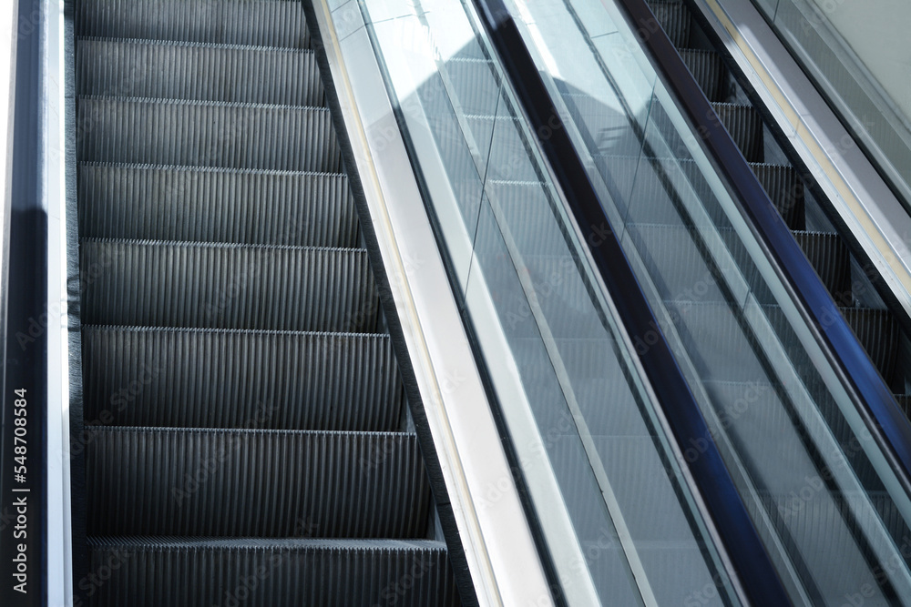Modern escalators with handrails in shopping mall, closeup Modern escalators with handrails in shopping mall, closeup